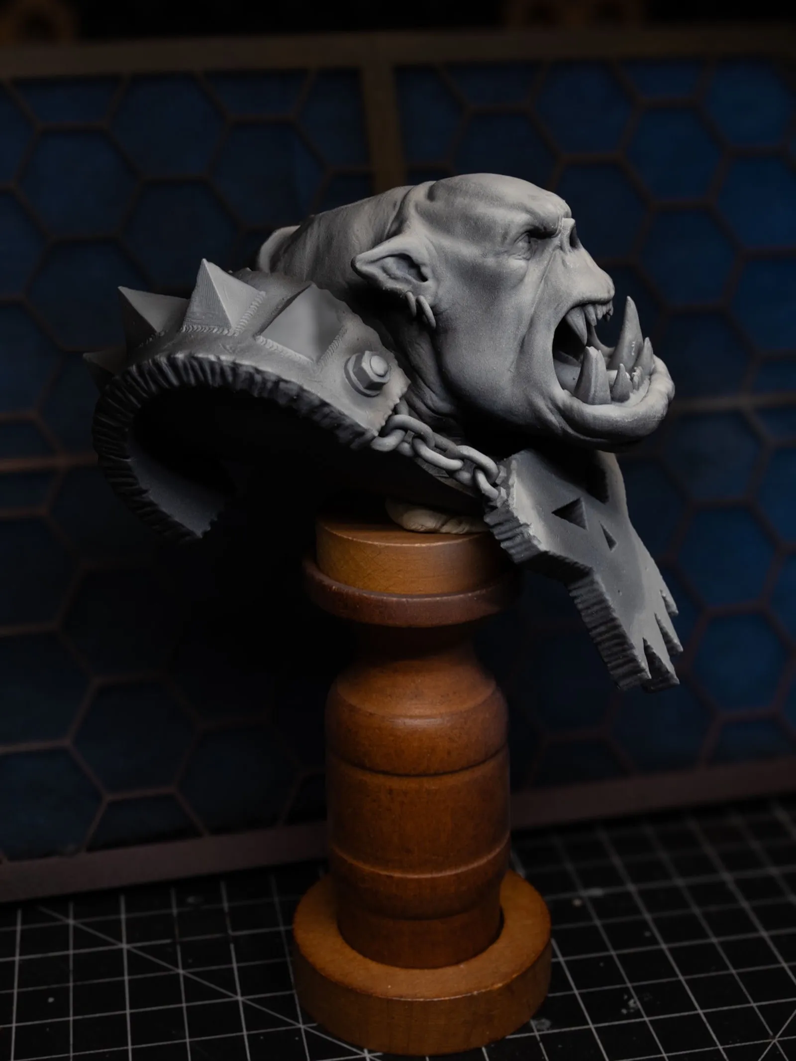 Ork bust zenithal from a third angle, deep shadows in mouth and under brow